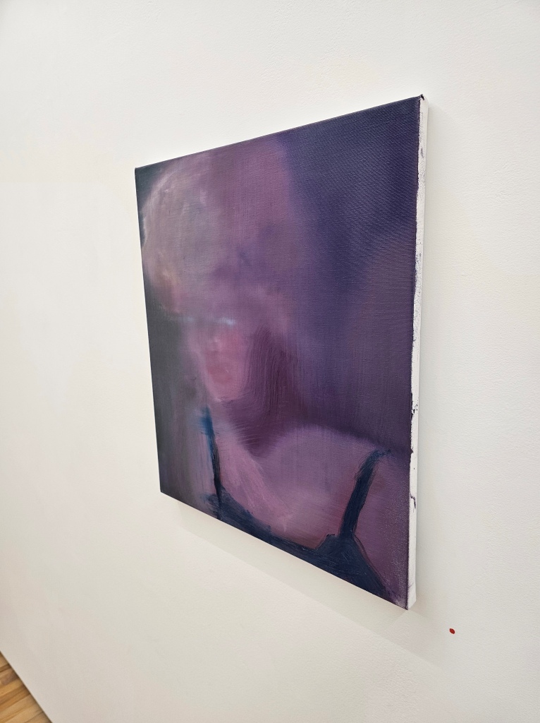 Blurry painting of Madonna impersonator on a white gallery wall
